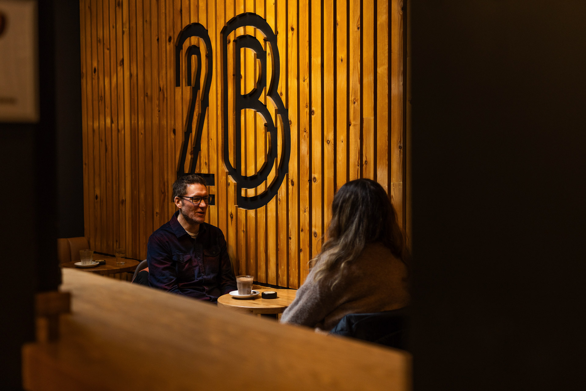 Garry working with a client in a coffee shop