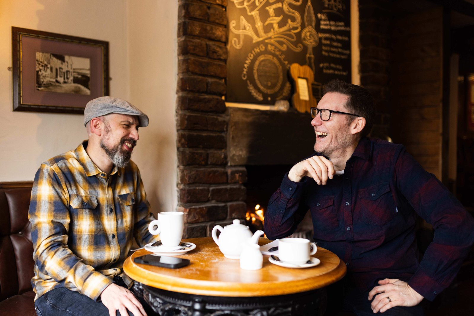 James and Garry laughing in a pub