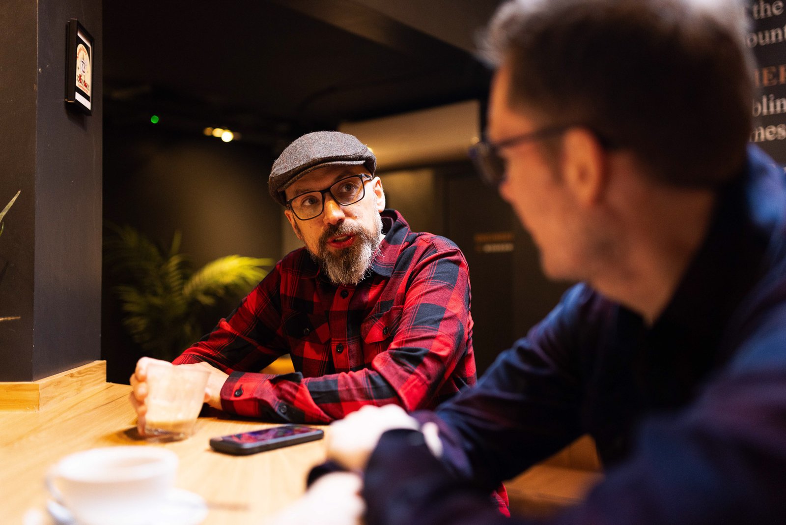 James and Garry talking in a cafe